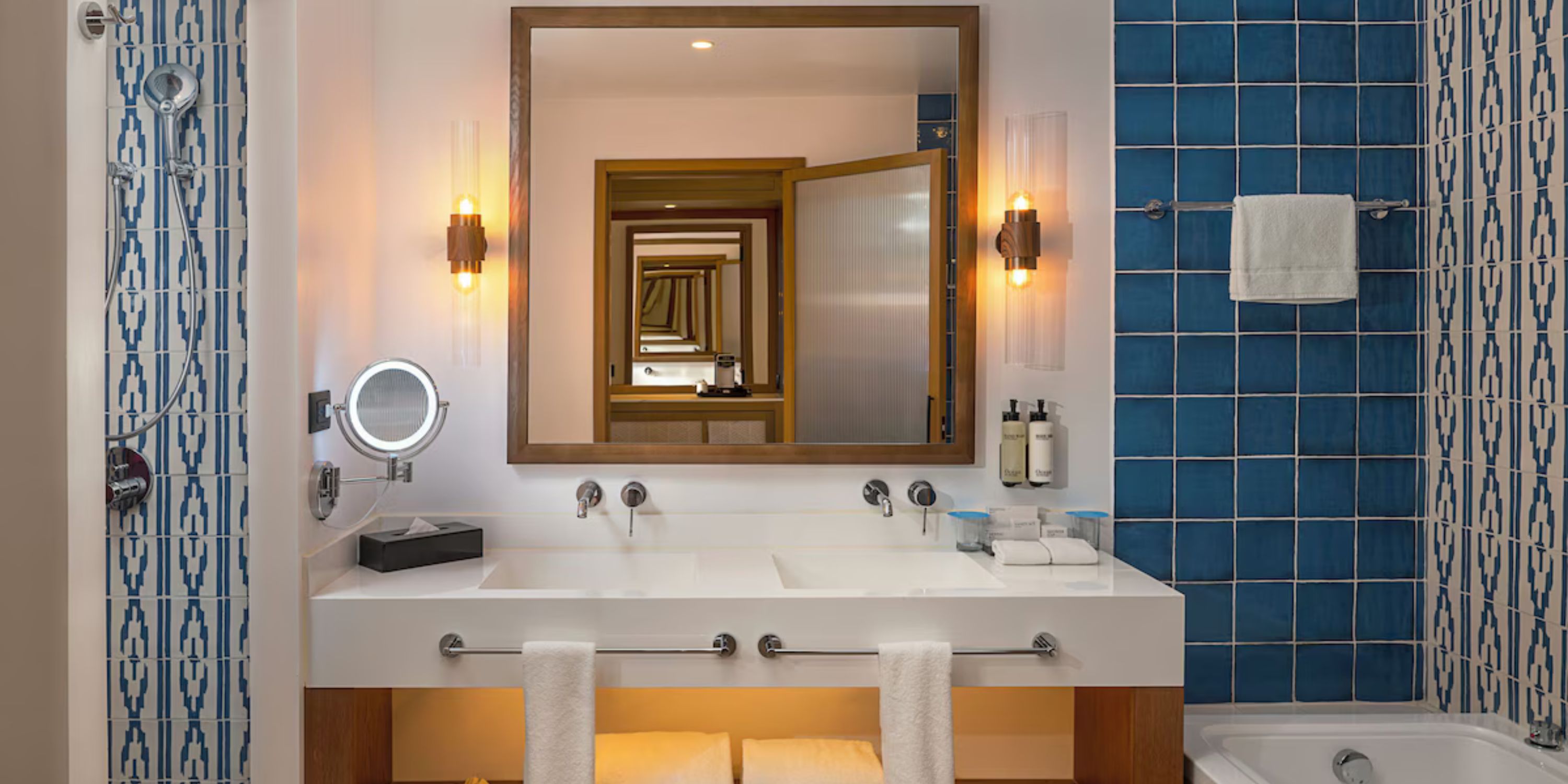 Modern bathroom with blue tiles and double sink at Ocean Coral and Turquesa, ideal for destination weddings.