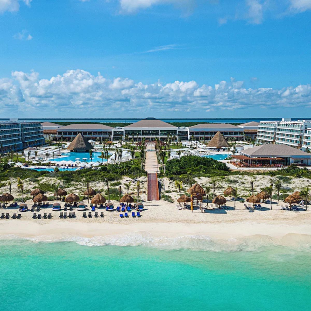 Ocean Coral and Turquesa, a beachfront resort perfect for destination weddings, pools, and palm trees.