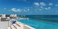 Infinity pool at Ocean Coral and Turquesa, ideal for a destination wedding with ocean views and lounge chairs.