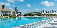 Ocean Coral and Turquesa's large pool with lounge chairs and palm trees is ideal for a destination wedding.