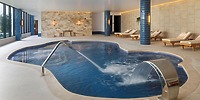 Indoor spa pool at Ocean Coral and Turquesa, ideal for destination wedding relaxation, with jets and lounge chairs.