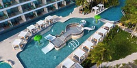 Aerial view of Sandos Playacar resort pool, ideal for a destination wedding, with cabanas, slides, and a guitar-shaped feature.