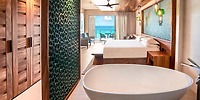 Elegant Sandos Playacar room with king bed, freestanding tub & ocean-view balcony for destination weddings.