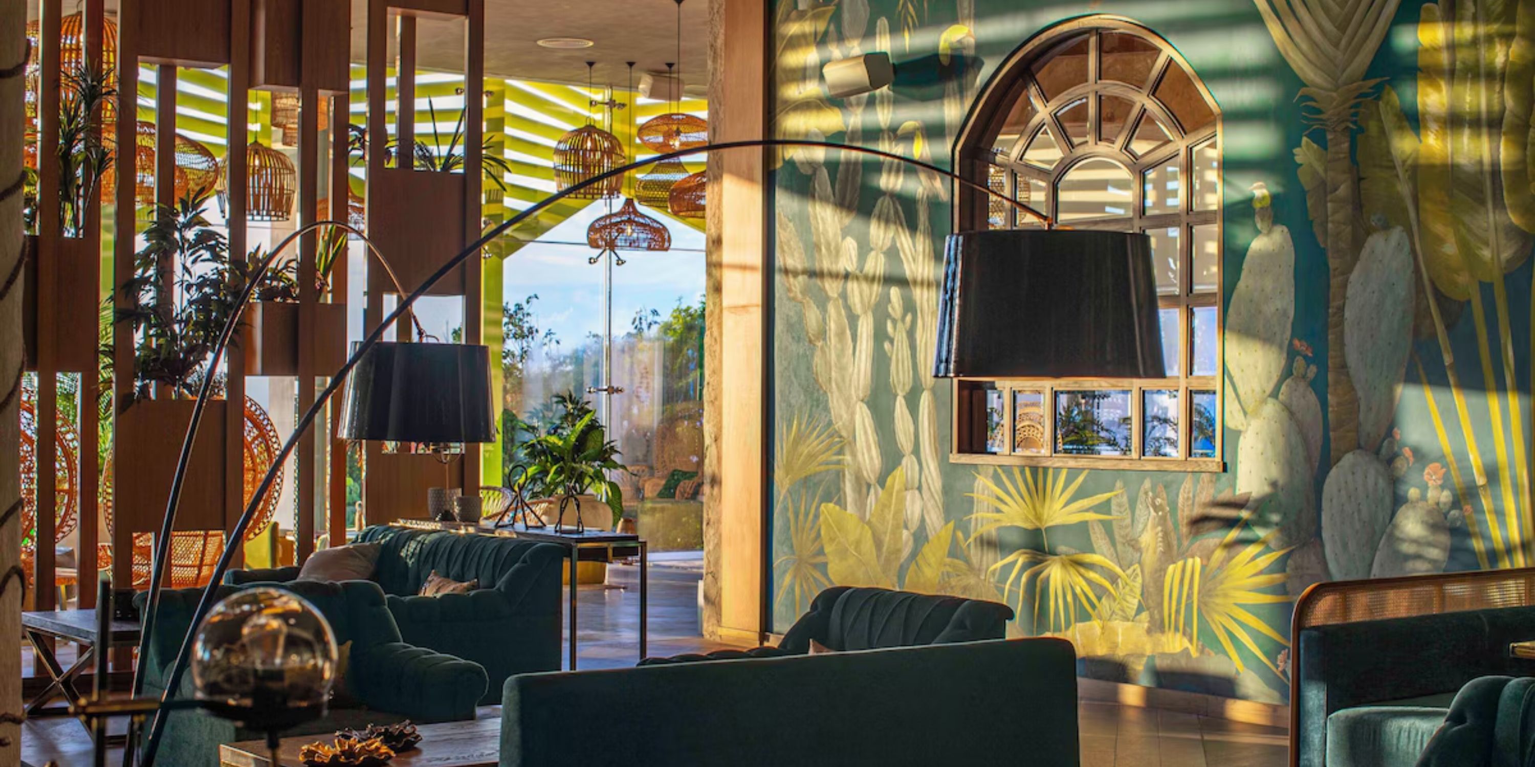 Bright lobby at Sandos Playacar, ideal for destination weddings, with modern decor and nature mural.