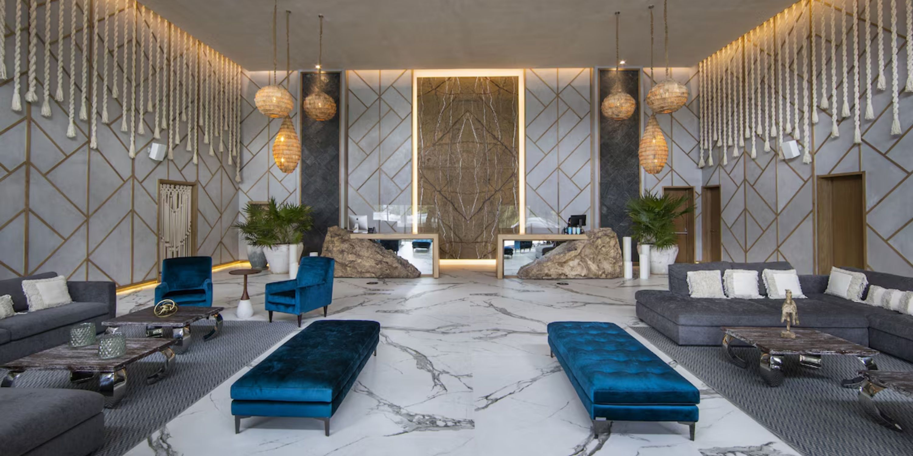 Sandos Playacar lobby: a chic destination wedding setting with marble floors, blue seats, and elegant lighting.