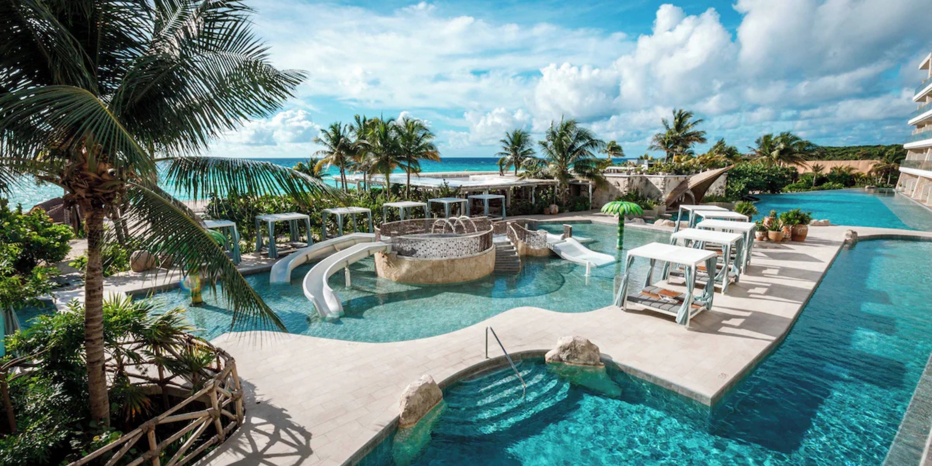 Sandos Playacar offers a resort pool with slides, cabanas, palm trees, and stunning wedding views.