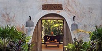 A wooden doorway labeled &ldquo;Sandos Playacar (Copy)&rdquo; opens to a room, perfect for a destination wedding.