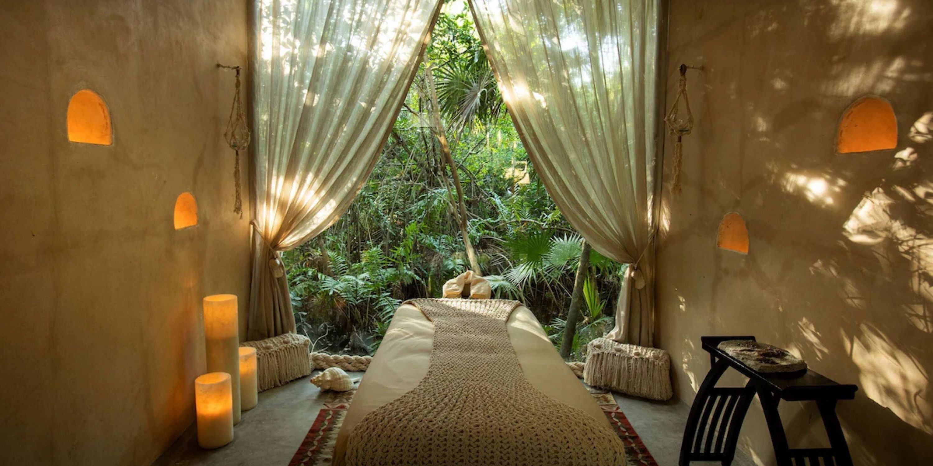 Massage table at Sandos Playacar in a tranquil room with sheer curtains, perfect for a destination wedding.