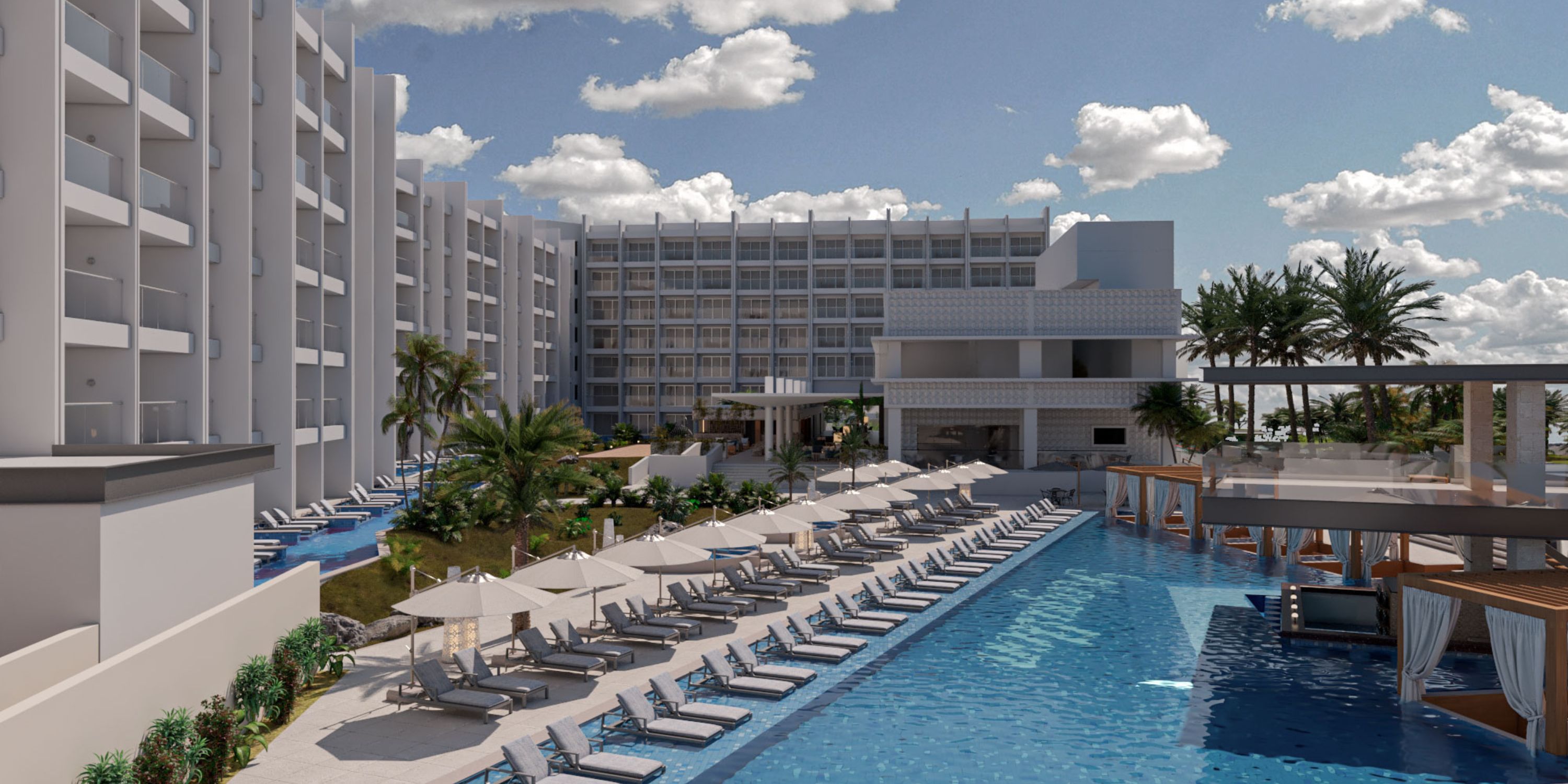 Royalton Chic Antigua's outdoor pool area is ideal for a destination wedding, with loungers and umbrellas.