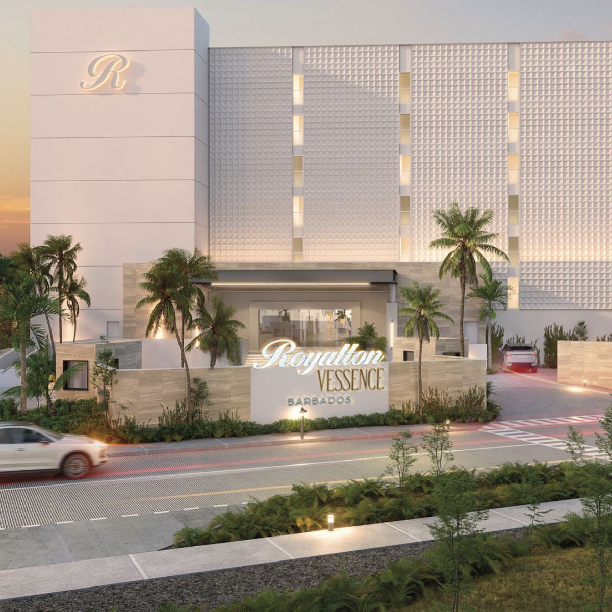 Entrance of Royalton Chic Antigua hotel at sunset, palm trees and cars, perfect for a destination wedding.