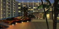Royalton Chic Antigua exterior at dusk, perfect for a destination wedding, with lit entrance, palms, gardens.