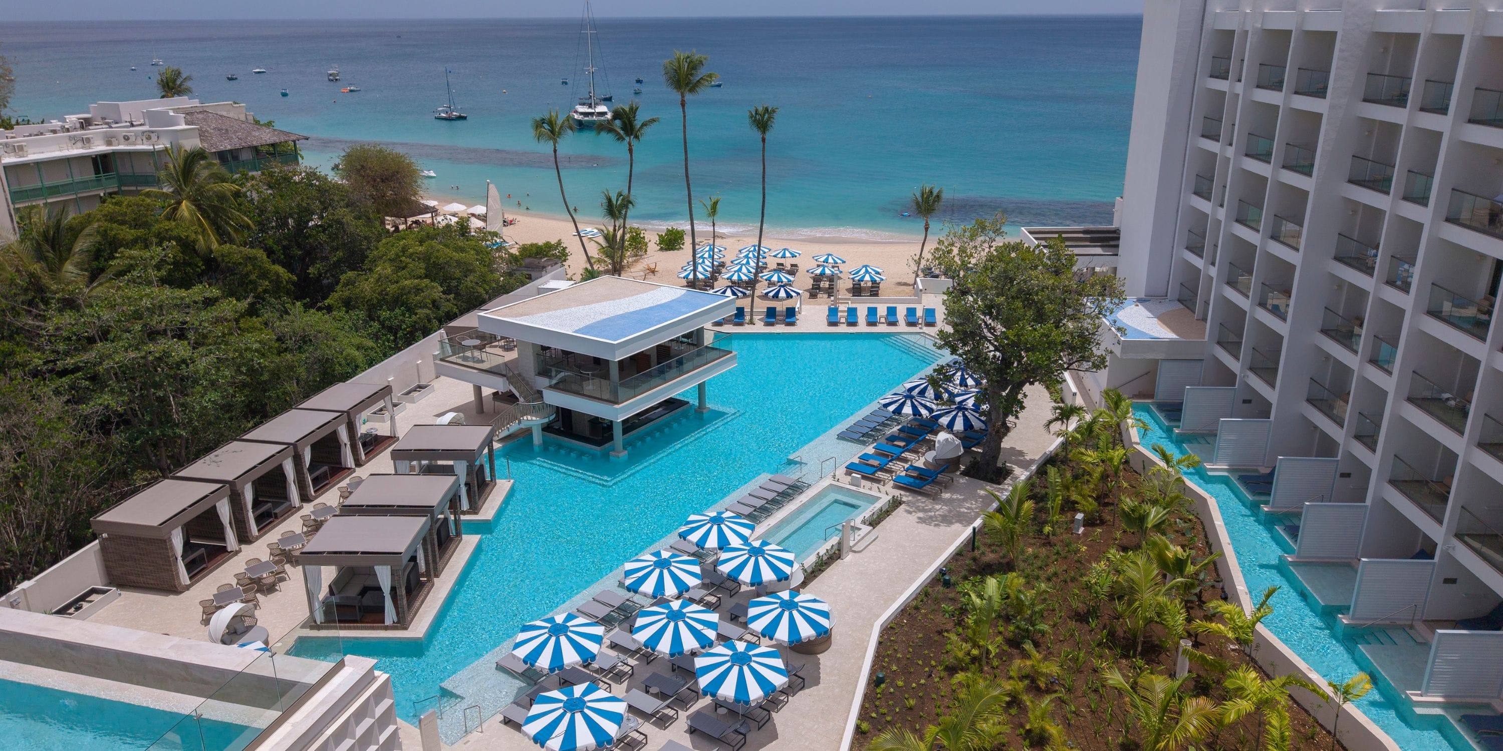 Royalton Vessence Barbados: beachfront resort with pools, cabanas; ideal for destination weddings.