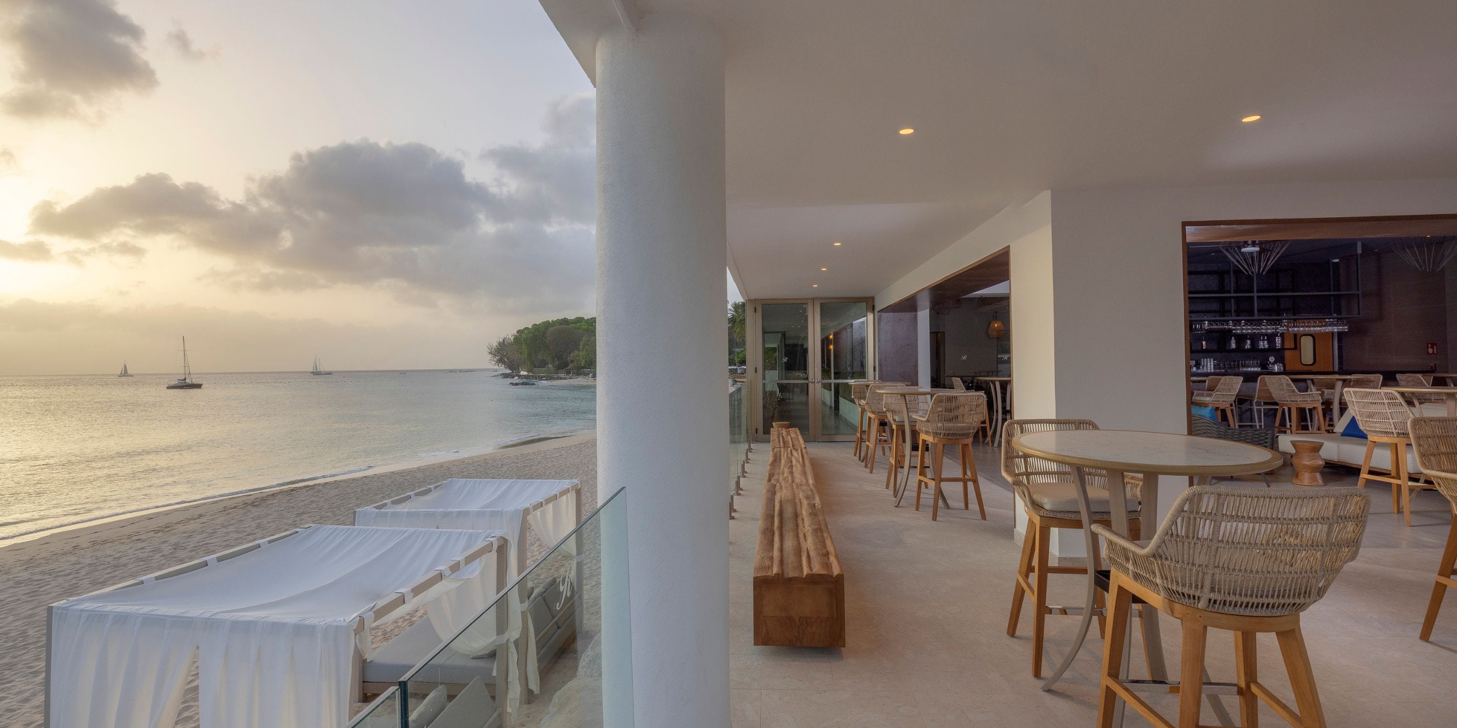 Royalton Vessence Barbados: dreamy destination wedding dining with wicker chairs and canopy beds.