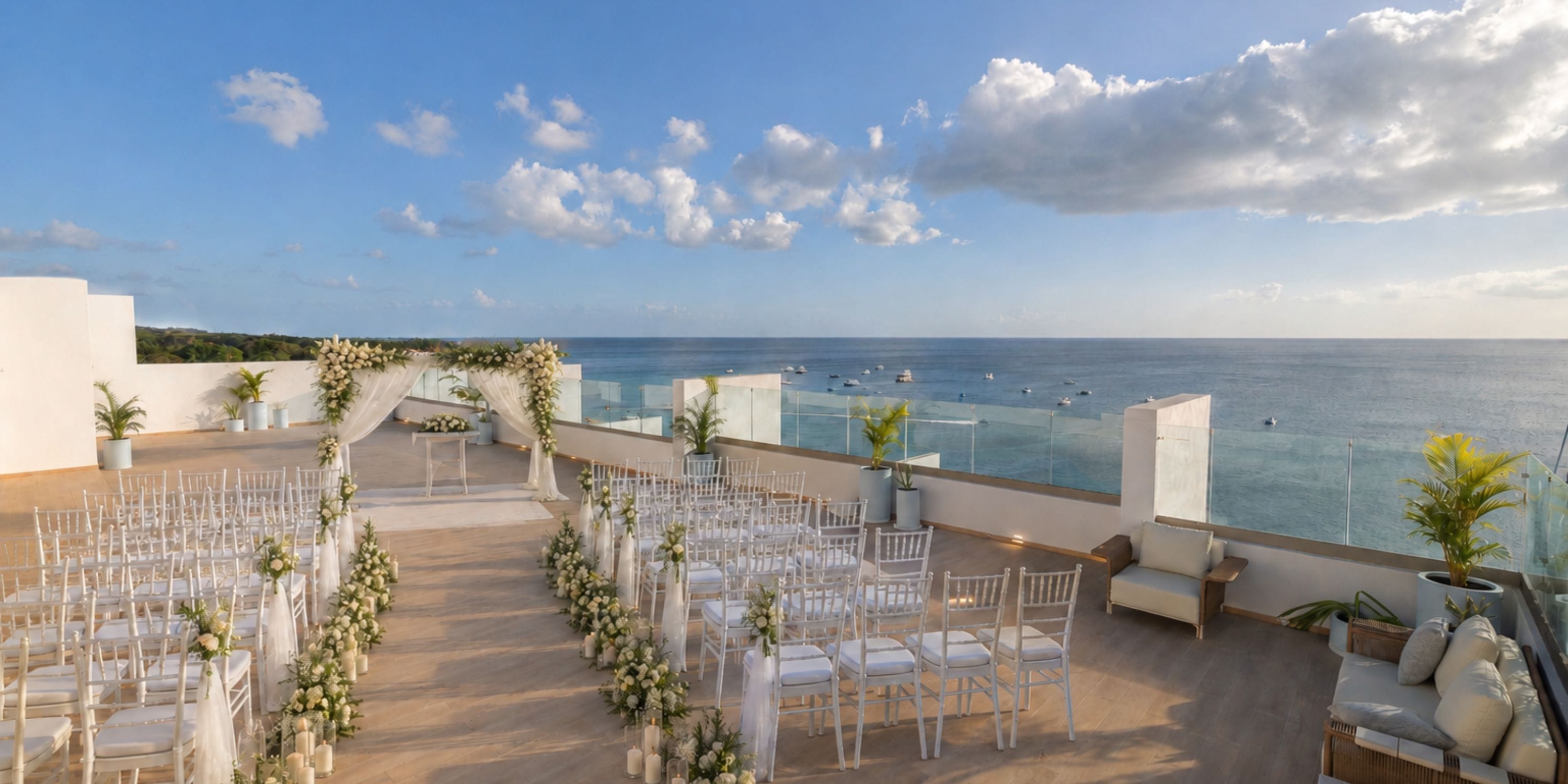 Destination wedding at Royalton Vessence Barbados: rooftop chairs, floral decor, ocean backdrop.