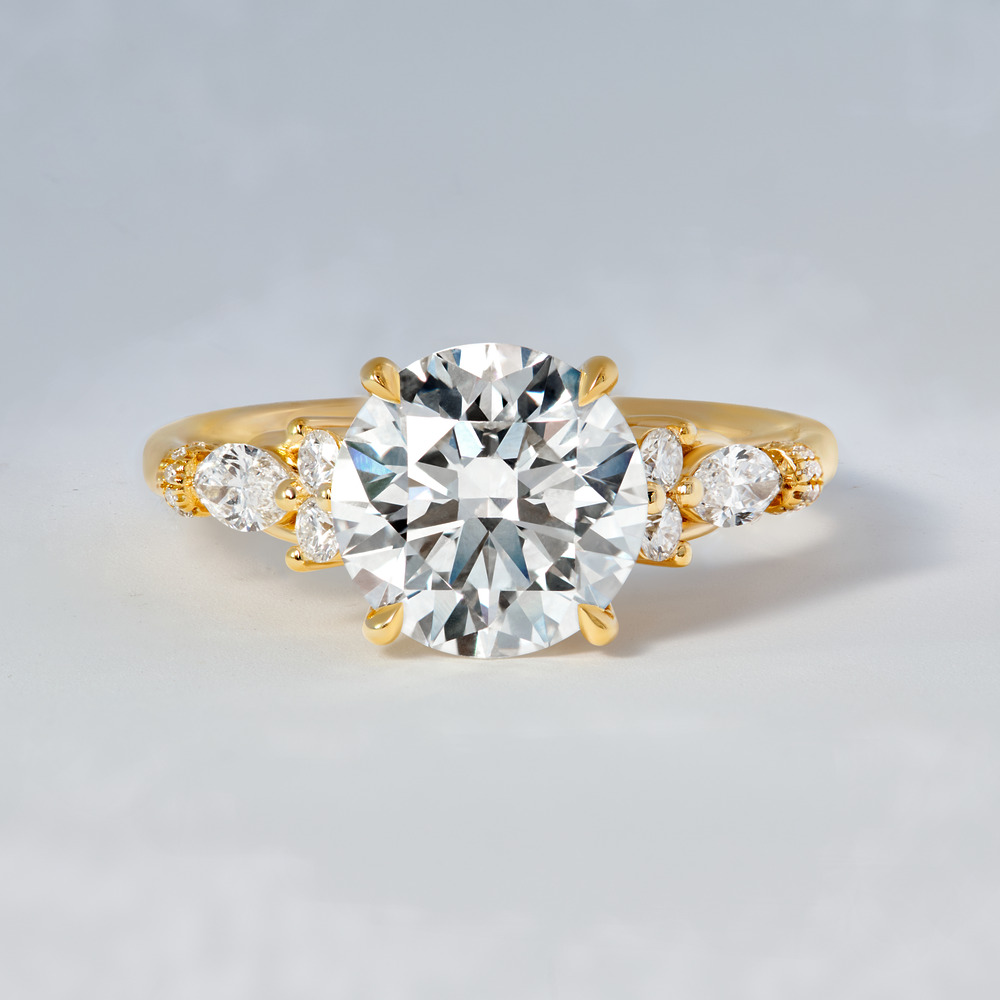 Elegant wedding gold ring featuring a large round diamond center and smaller side diamonds, perfect for a destination wedding.