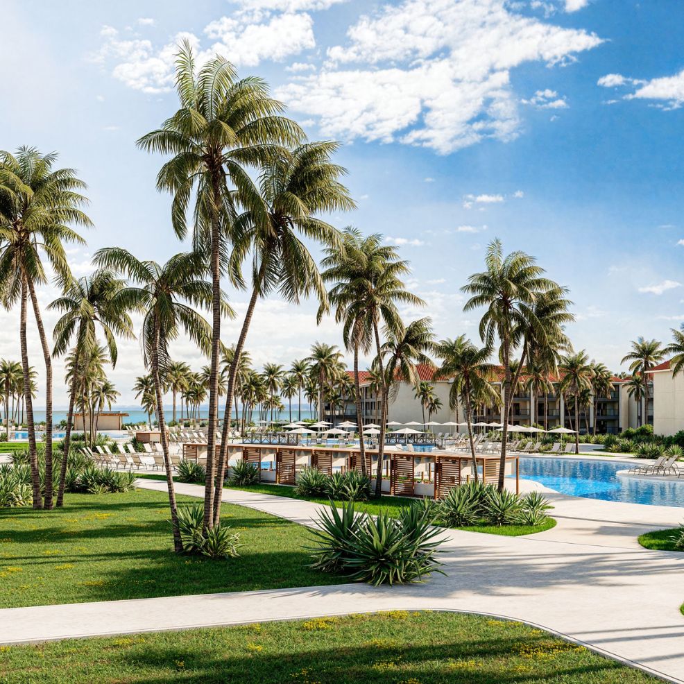 Palm trees border a large pool at a resort, perfect for a destination wedding with ocean views.