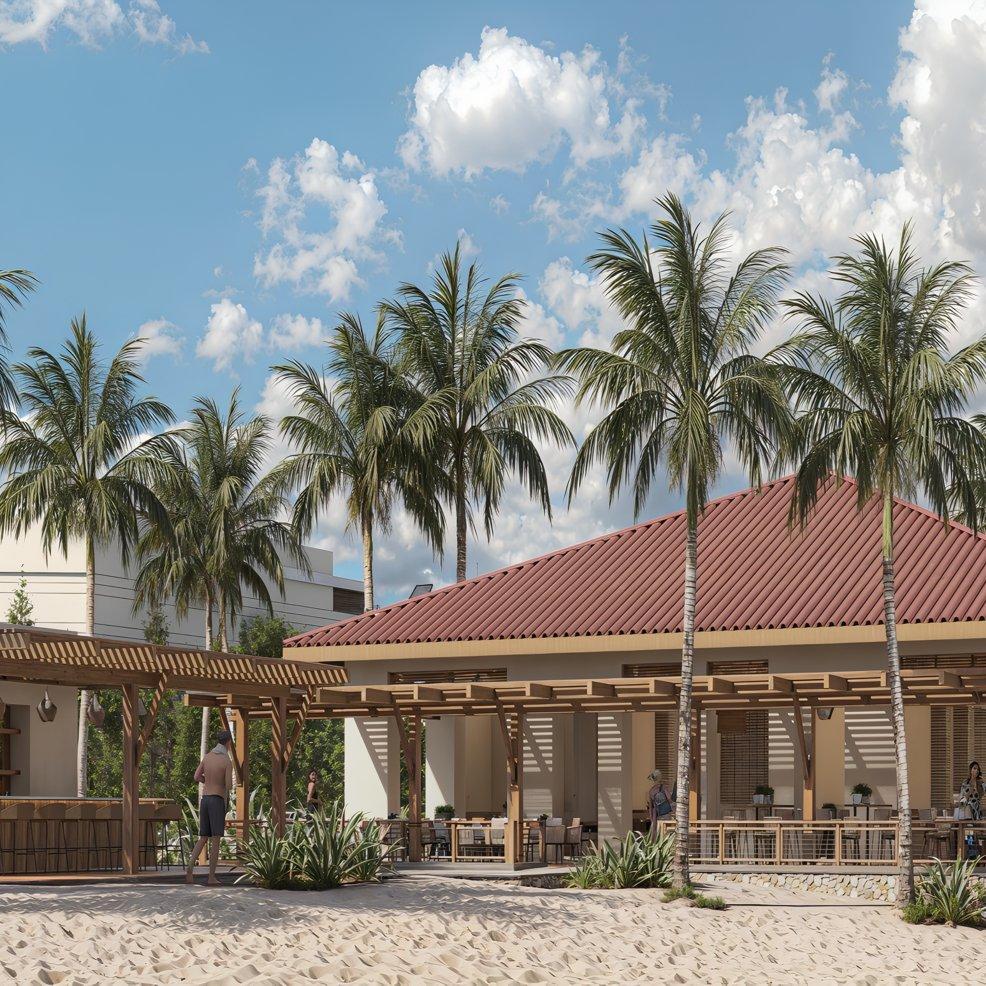 Beachside restaurant set up for a destination wedding, with palm trees, sand, and guests at tables.
