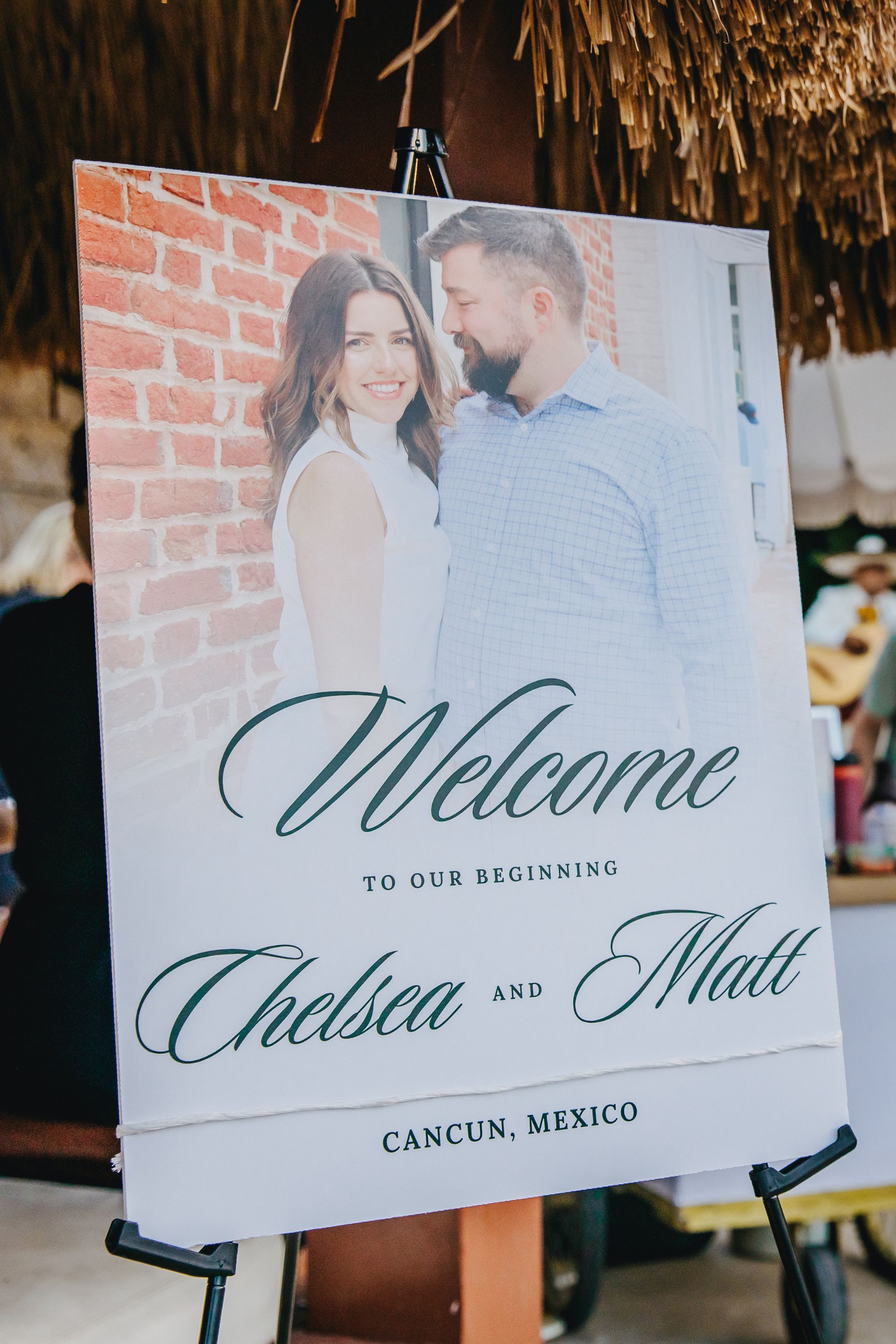 Destination wedding welcome sign with a couple's photo: &ldquo;Kathryn and Mike, Cancun, Mexico.&rdquo;.