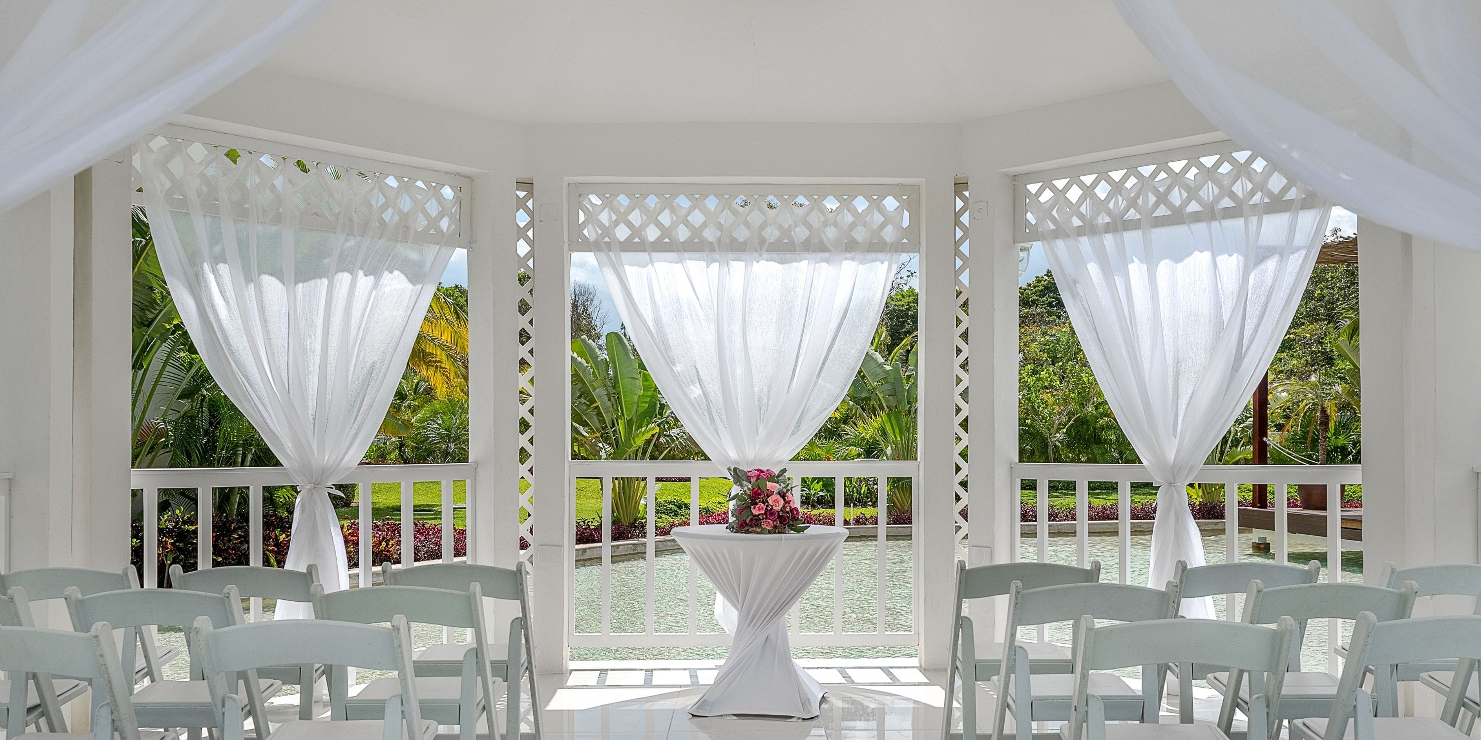 Ocean Riviera Paradise decorated for a destination wedding with elegant chairs, drapes, and florals.