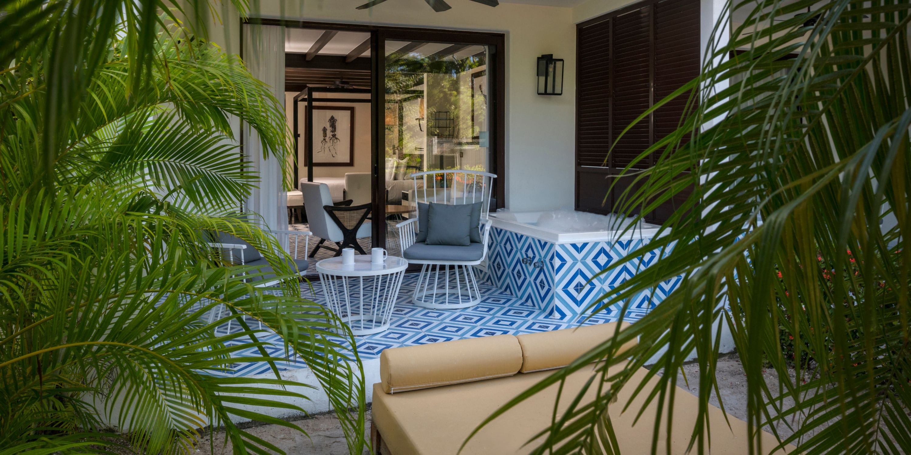 Ocean Riviera Paradise: patio with blue tiles, table, chairs, lush plants&mdash;ideal for a destination wedding.