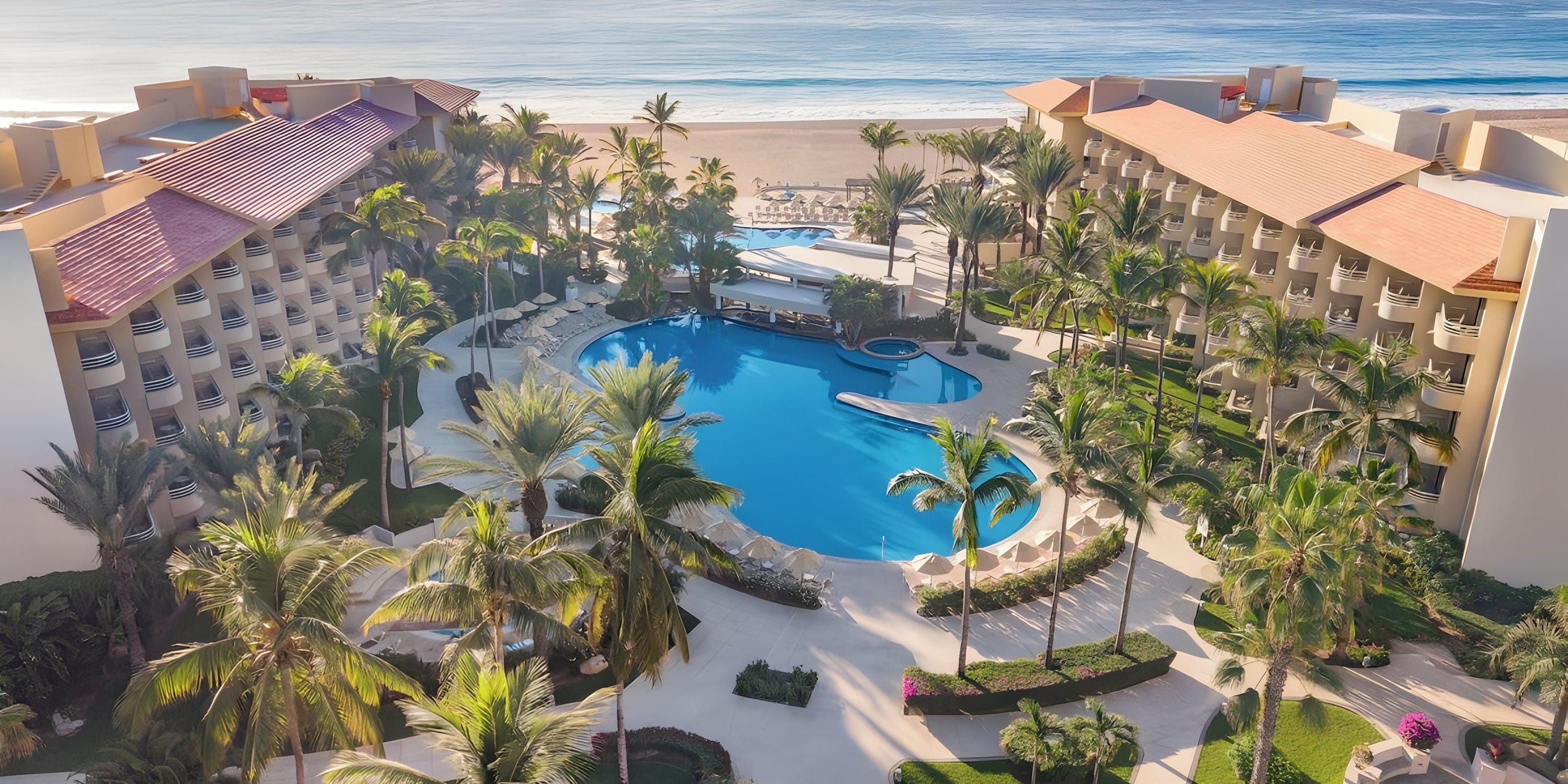 Aerial view of Barcel&oacute; Grand Faro Los Cabos, a stunning destination wedding spot with pool and palms.