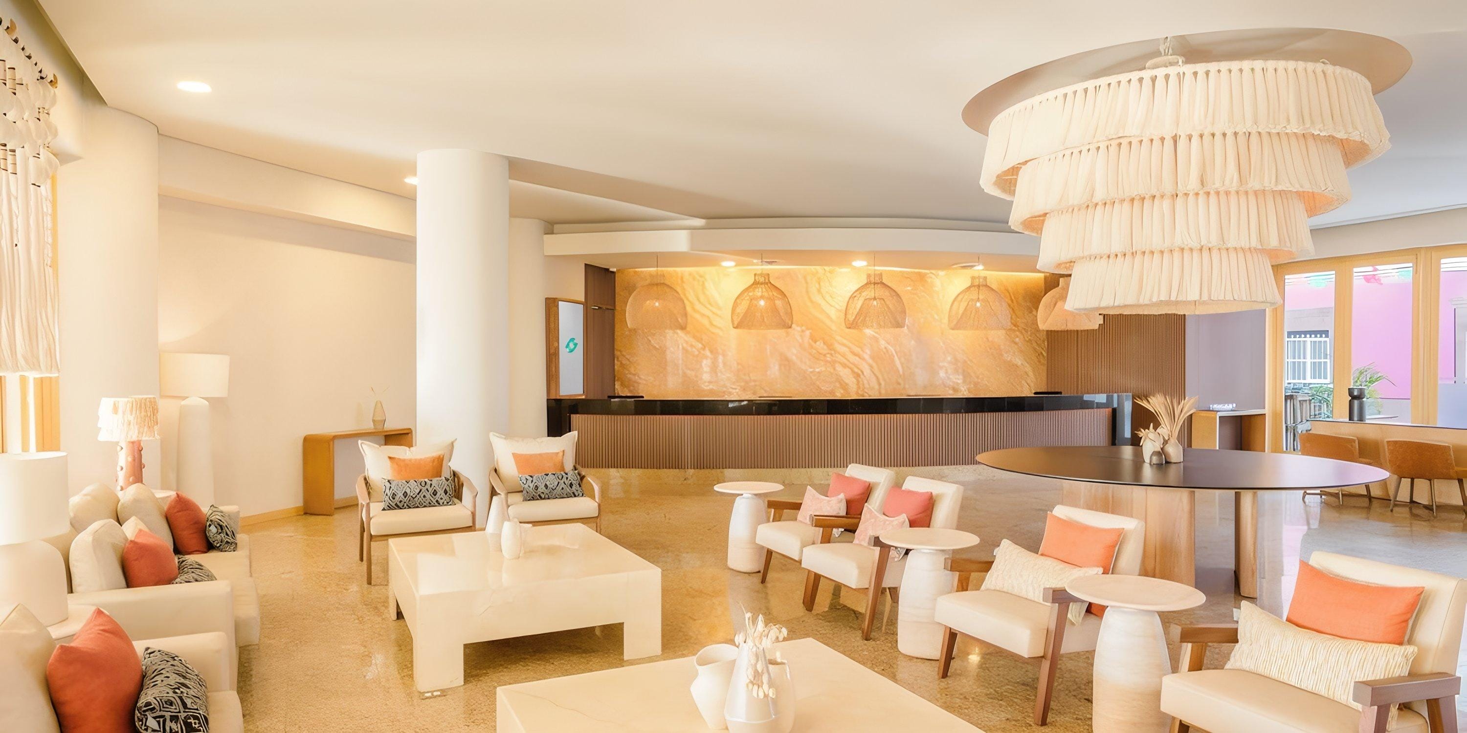 Elegant lobby at Barcel&oacute; Grand Faro Los Cabos, ideal for destination wedding arrivals, cream decor, chandelier.