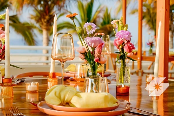 Barcel&oacute; Grand Faro Los Cabos: outdoor table set for a destination wedding with candles, flowers, and glassware.