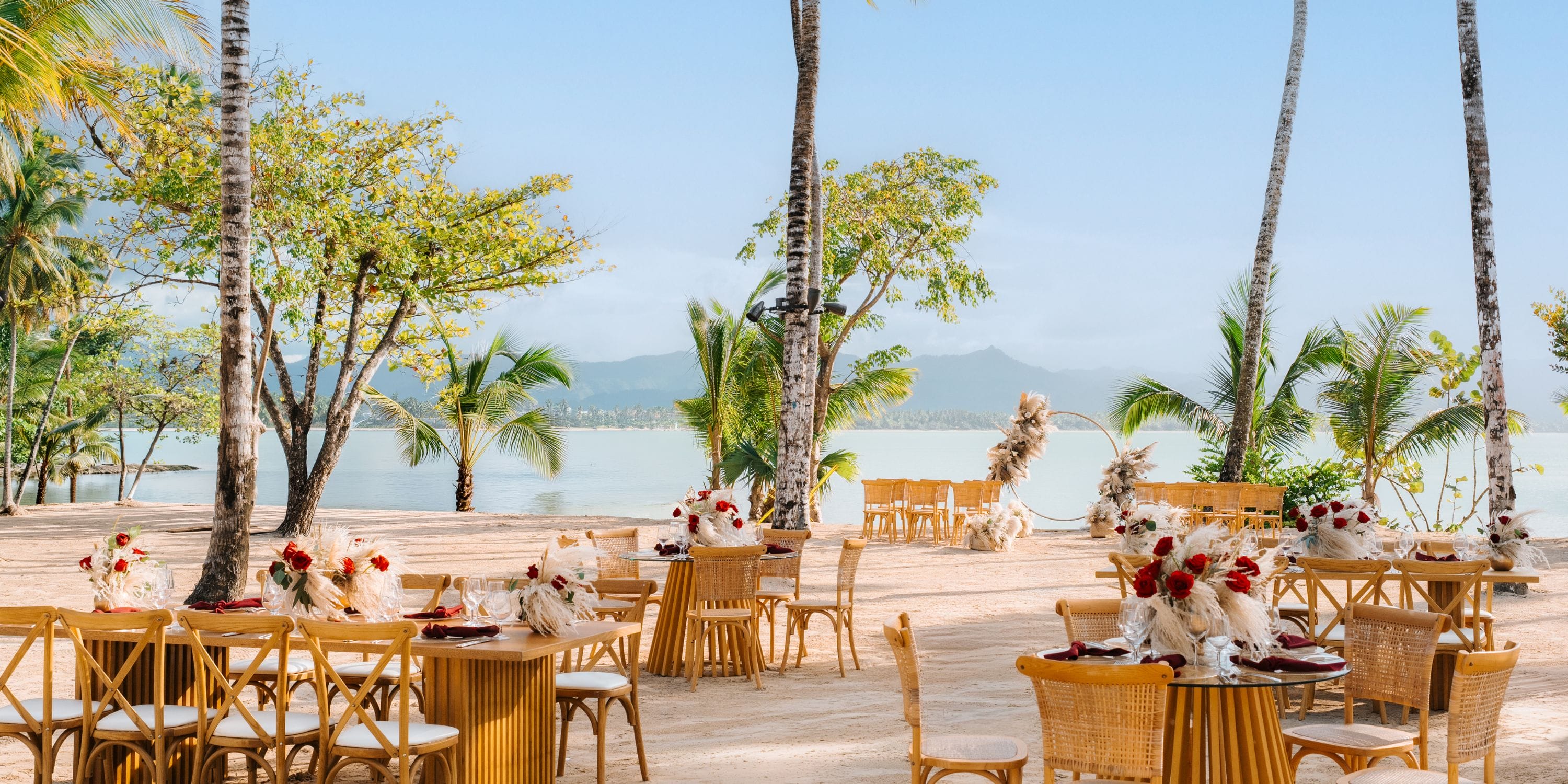 Zemi Miches Punta Cana outdoor wedding setup with decorated tables and wooden chairs for a destination wedding.