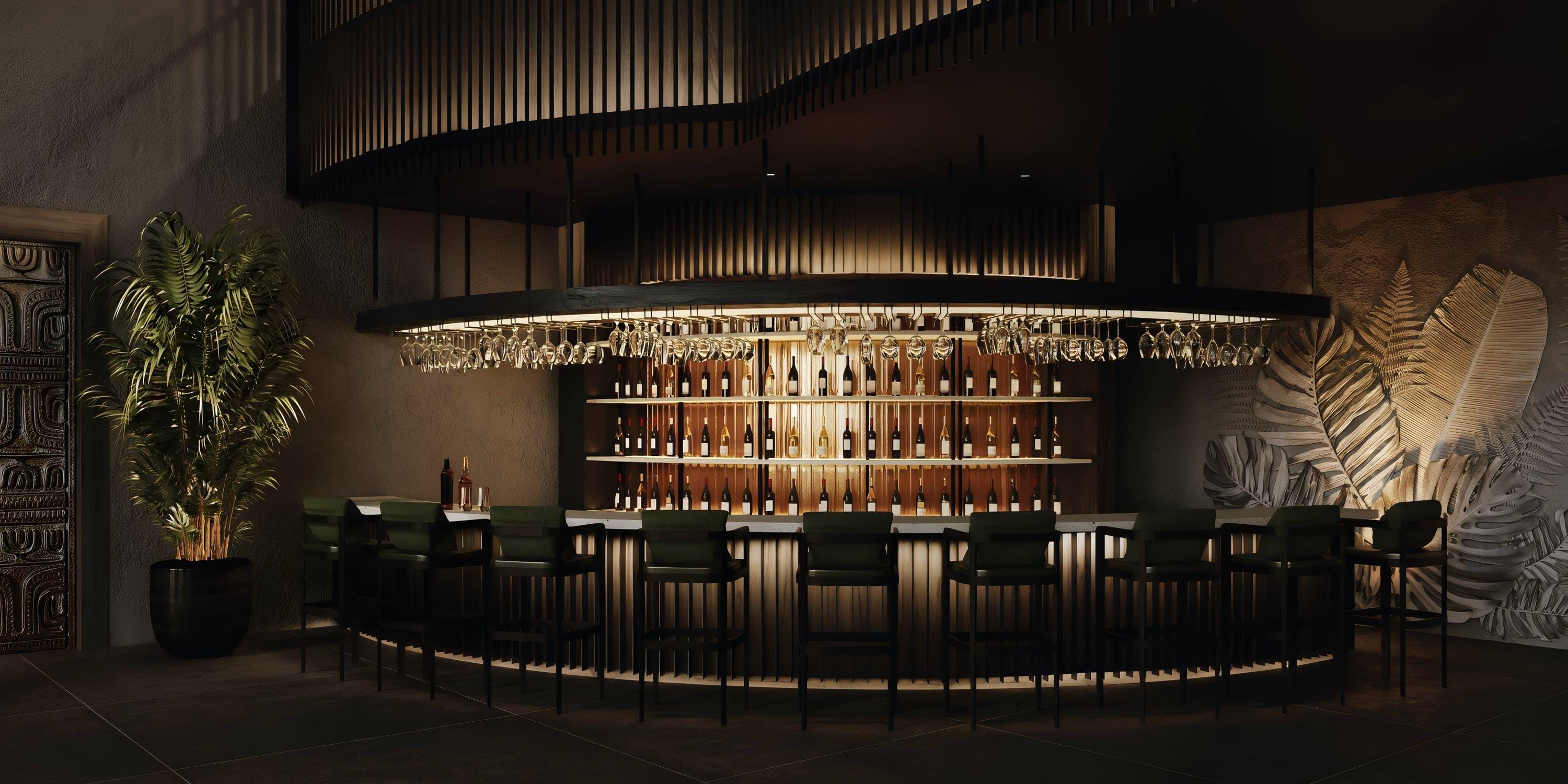 Lopesan Serenity Bay destination wedding bar: bottle shelves, pendant lights, green chairs, plant.