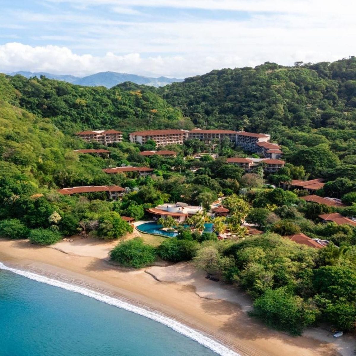 Aerial view of Dreams Las Mareas, a perfect destination wedding resort surrounded by lush forest.