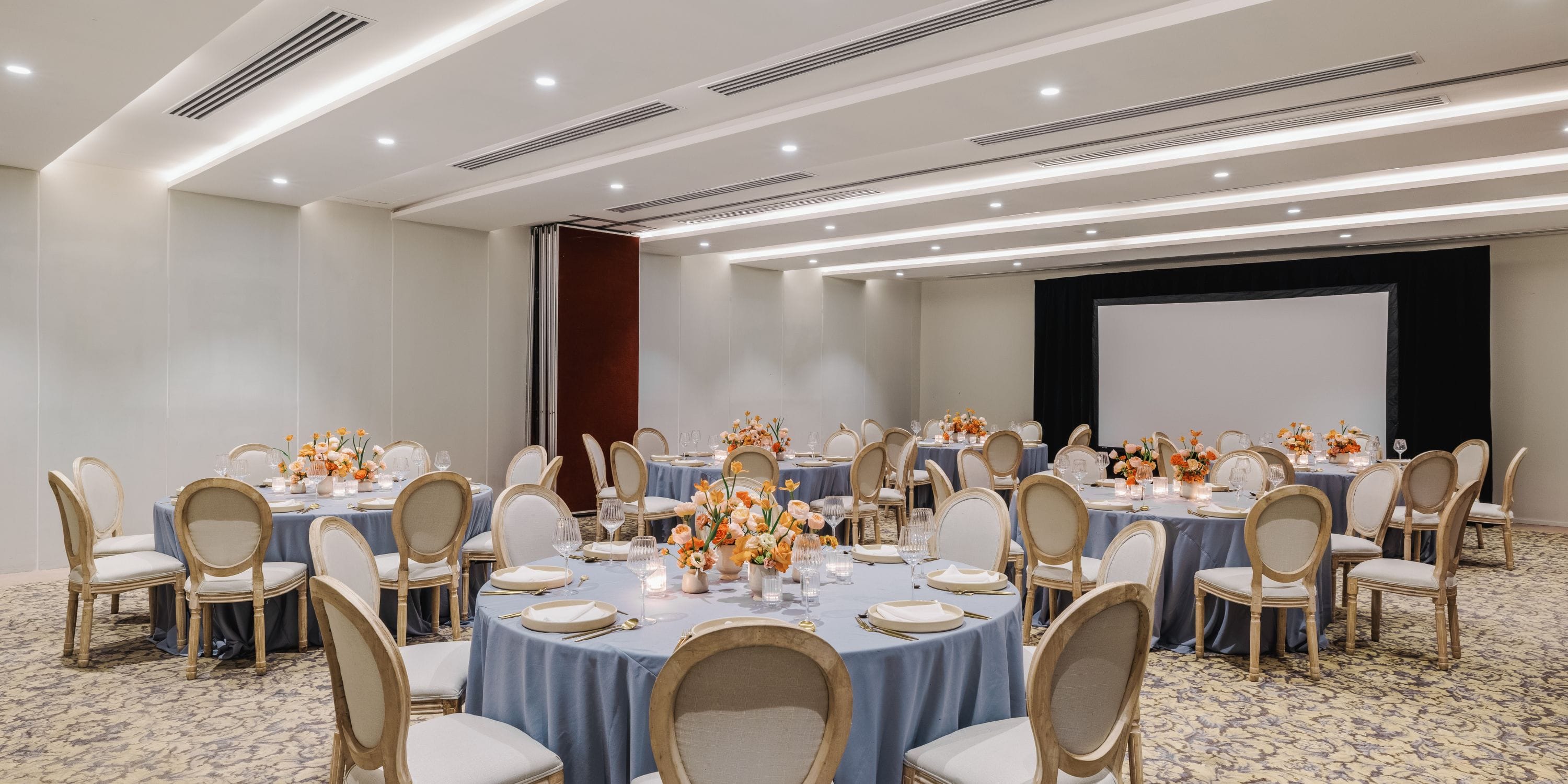 Elegant banquet hall set up for a destination wedding at Royalton Riviera Cancun, with floral decor.