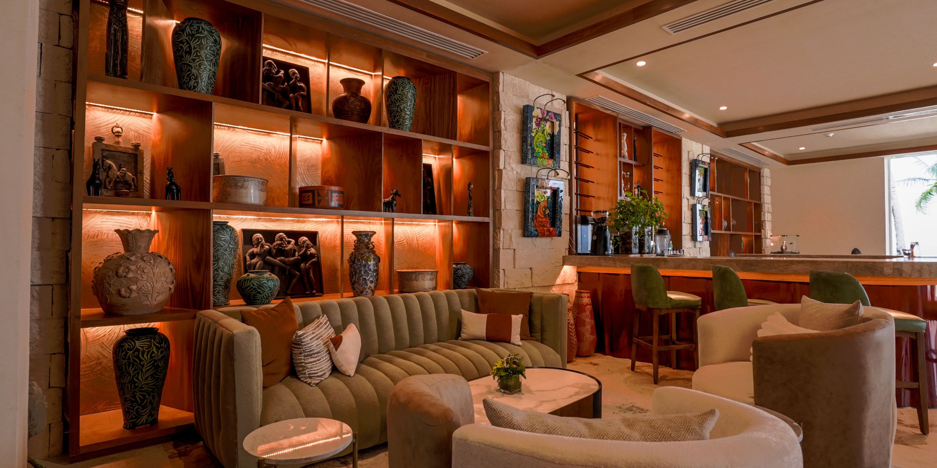 Elegant lounge with beige sofas, wood bar, ideal decor for a wedding or destination wedding event.