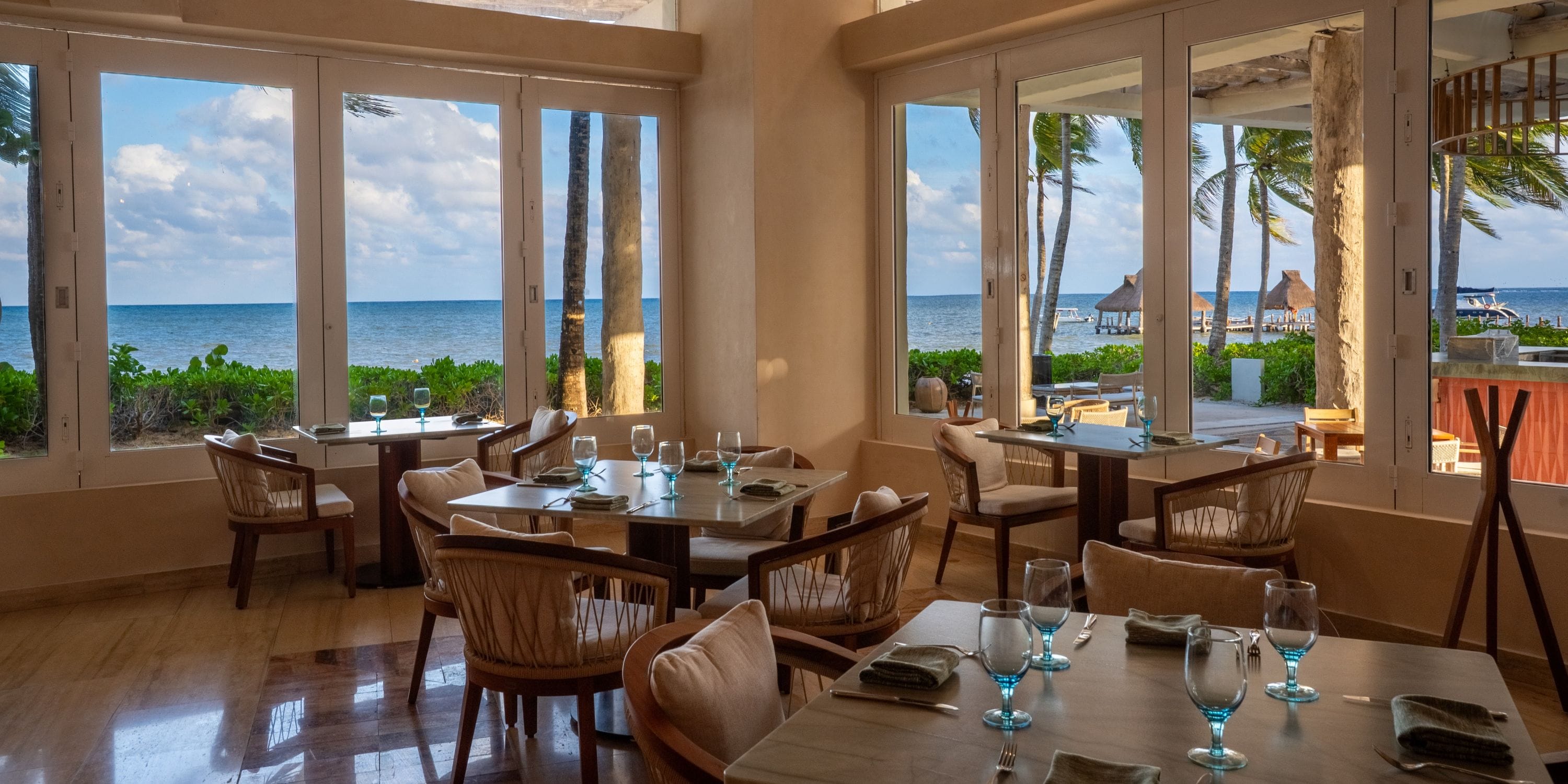 Elegant table settings with ocean views&mdash;an ideal spot for your dream destination wedding.