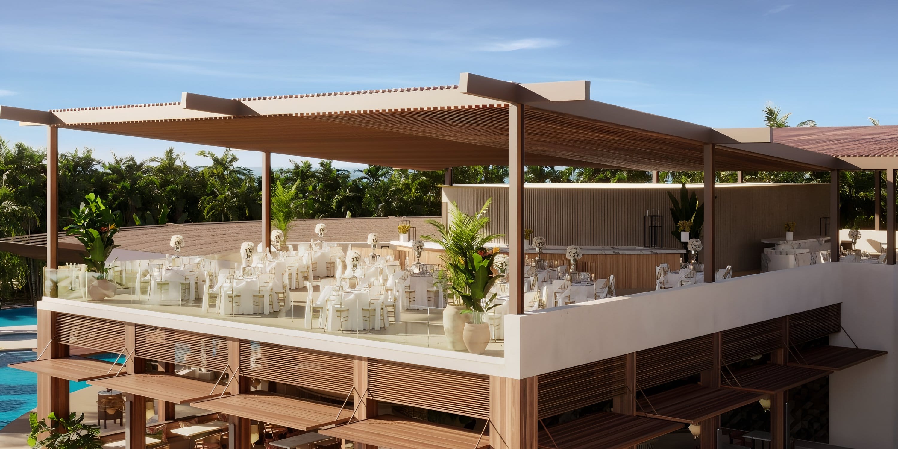 Elegant rooftop dining at Dreams Las Mareas for a destination wedding: white tables, greenery.