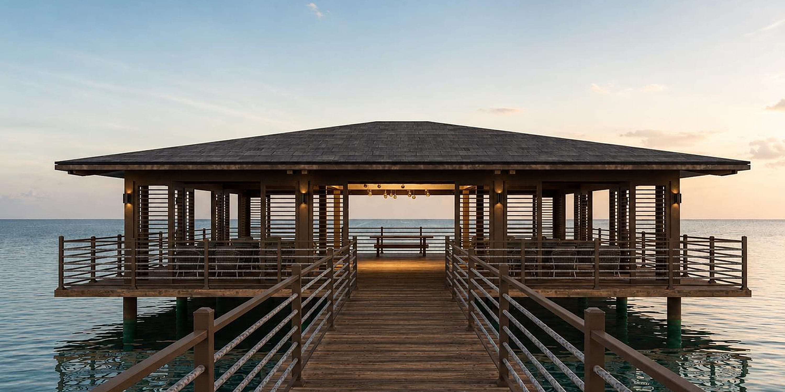 Wedding gazebo at UNICO 18°77° Montego Bay on a pier over calm ocean water.
