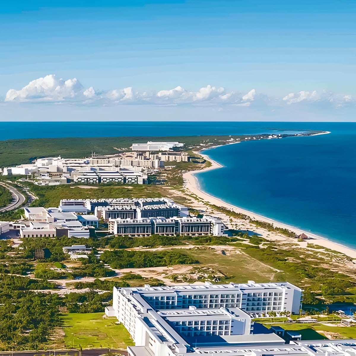 Aerial view of Hotel Riu Palace Quintana Roo, a stunning destination wedding spot by the blue ocean.