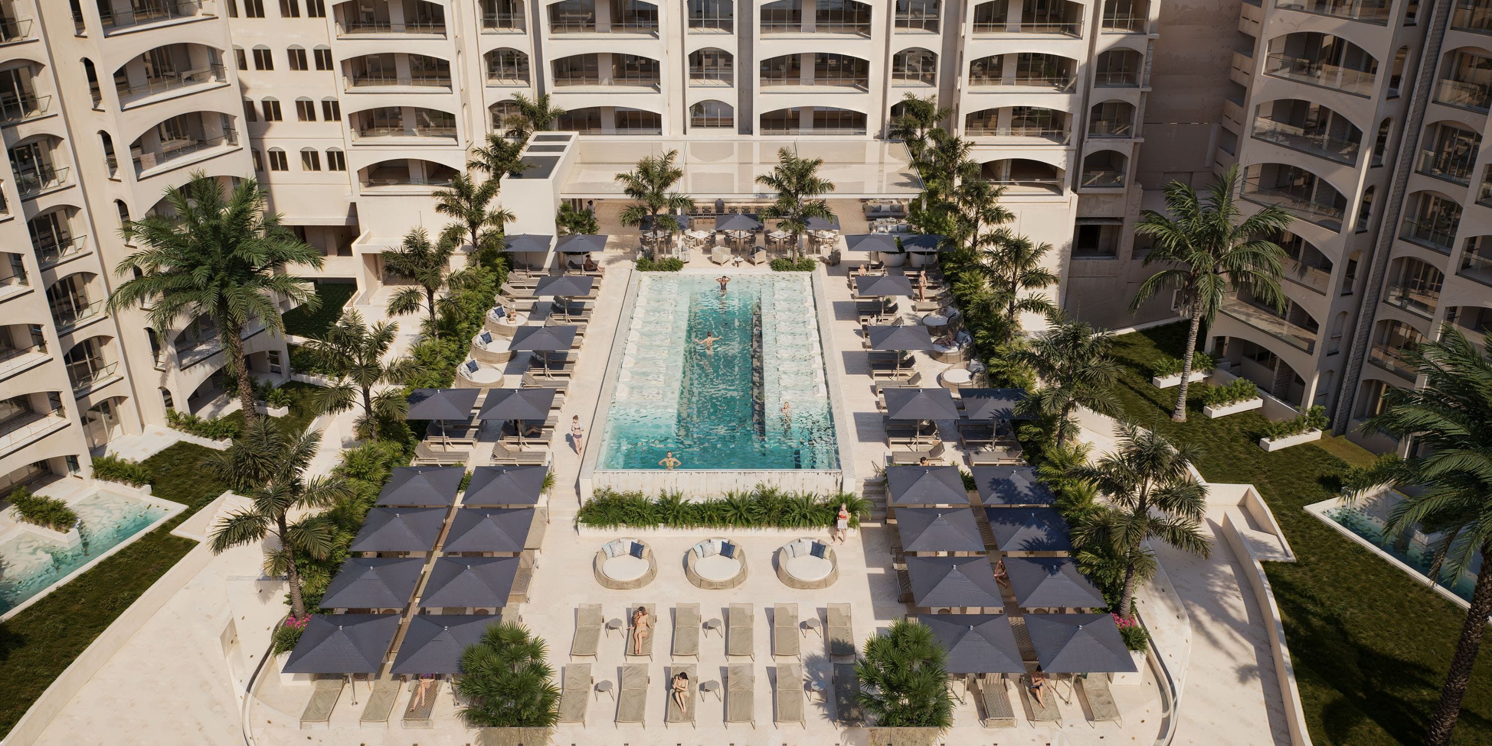 A rectangular pool at Royalton Riviera Cancun, perfect for a destination wedding, with palm trees.