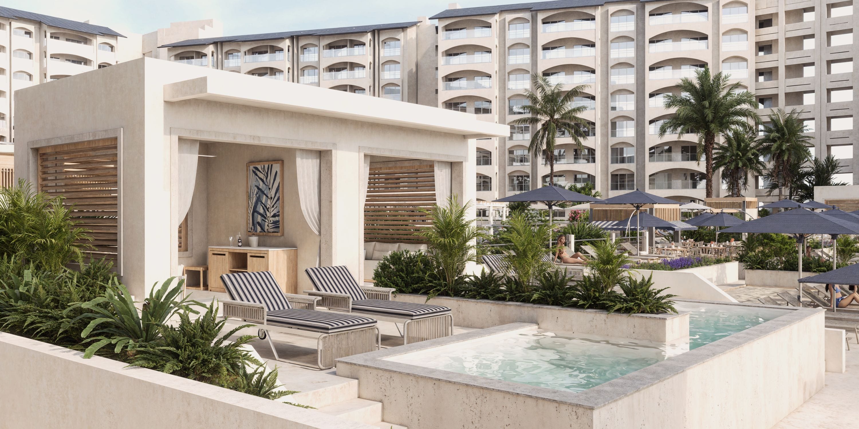 Relax in a luxury cabana with striped loungers and private pool, perfect for a destination wedding.