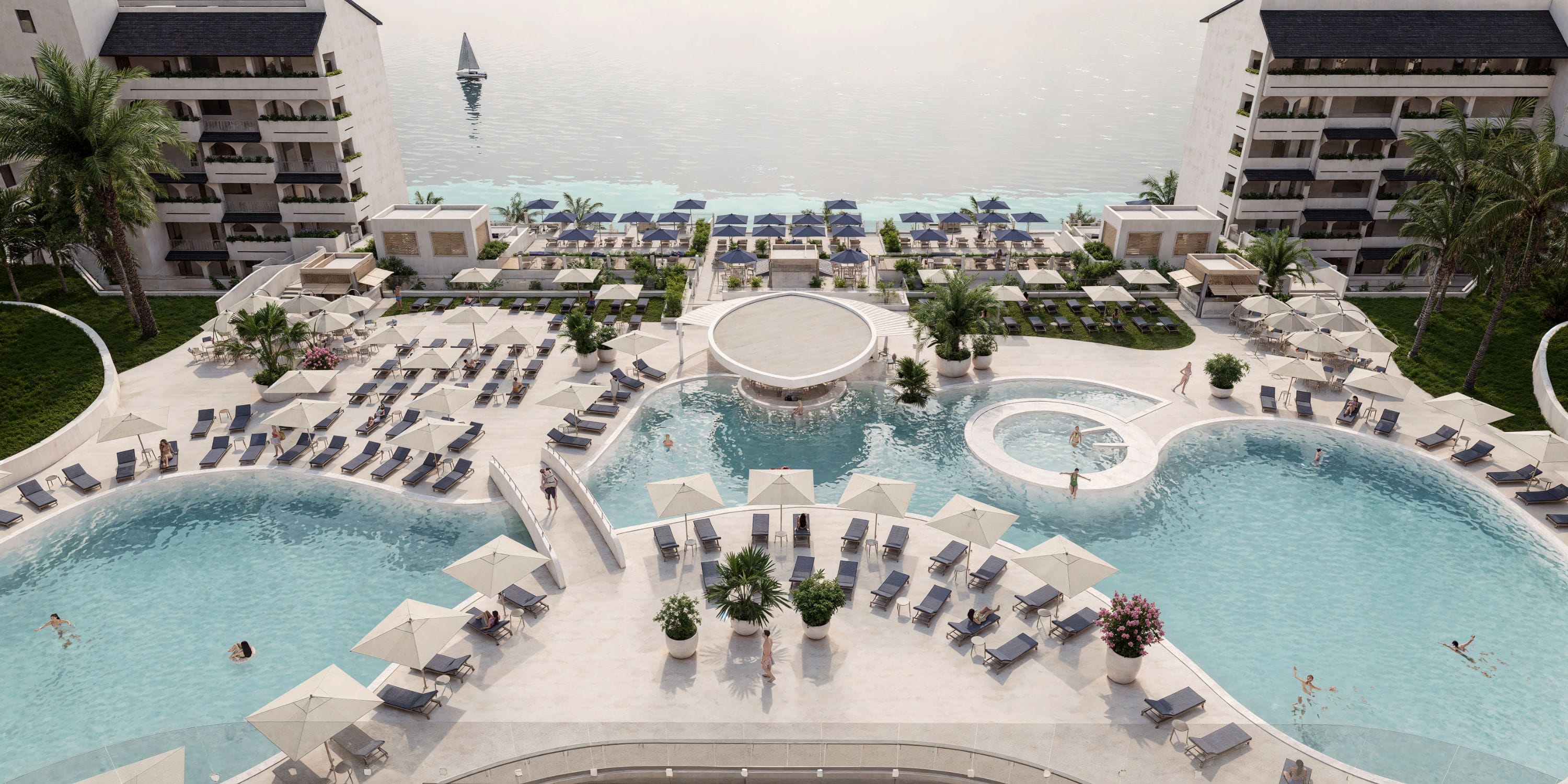 Resort pool with loungers and umbrellas, perfect for a Royalton Riviera Cancun destination wedding.