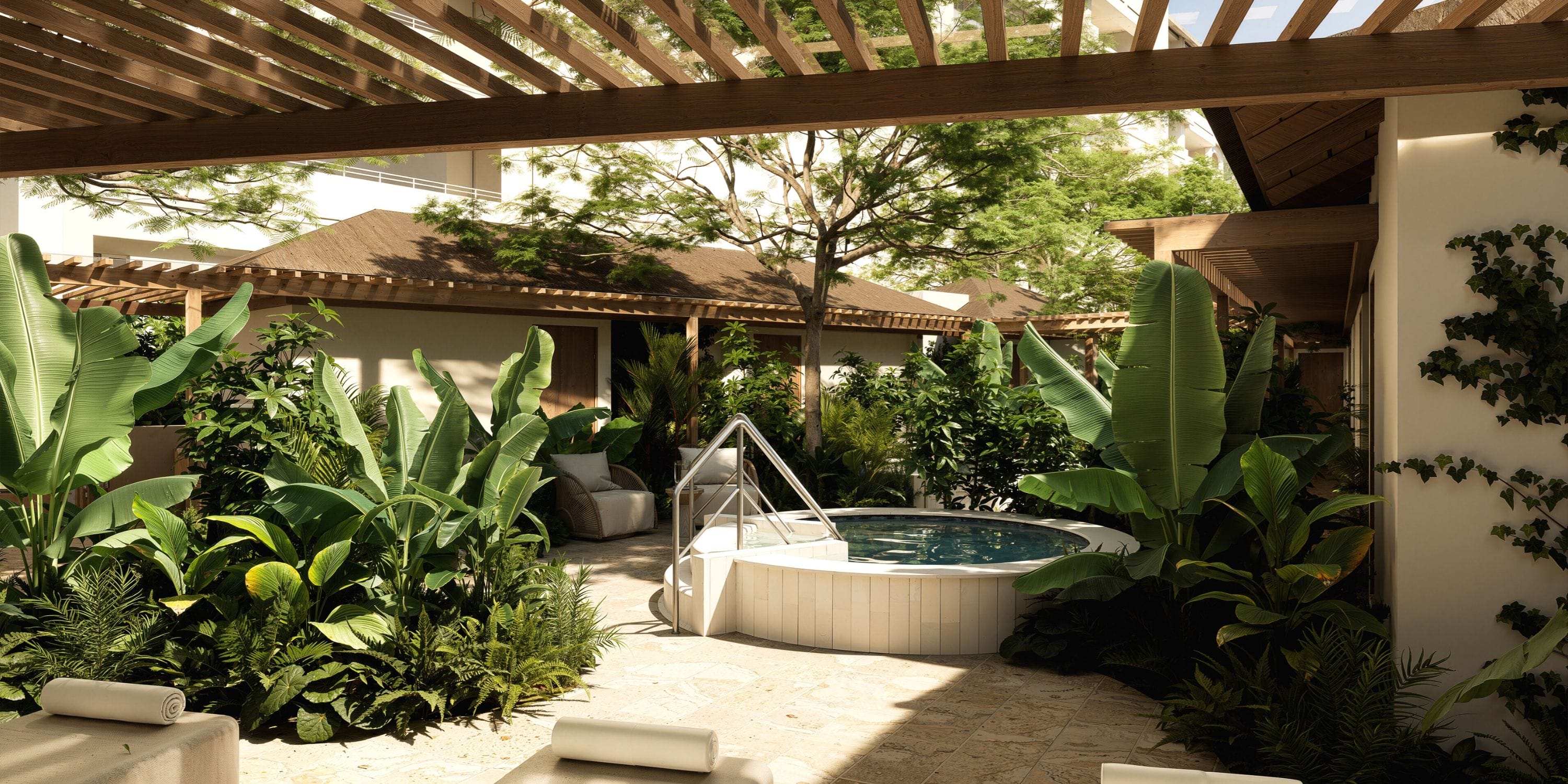 Patio with round hot tub, loungers, and lush plants&mdash;ideal for a destination wedding celebration.