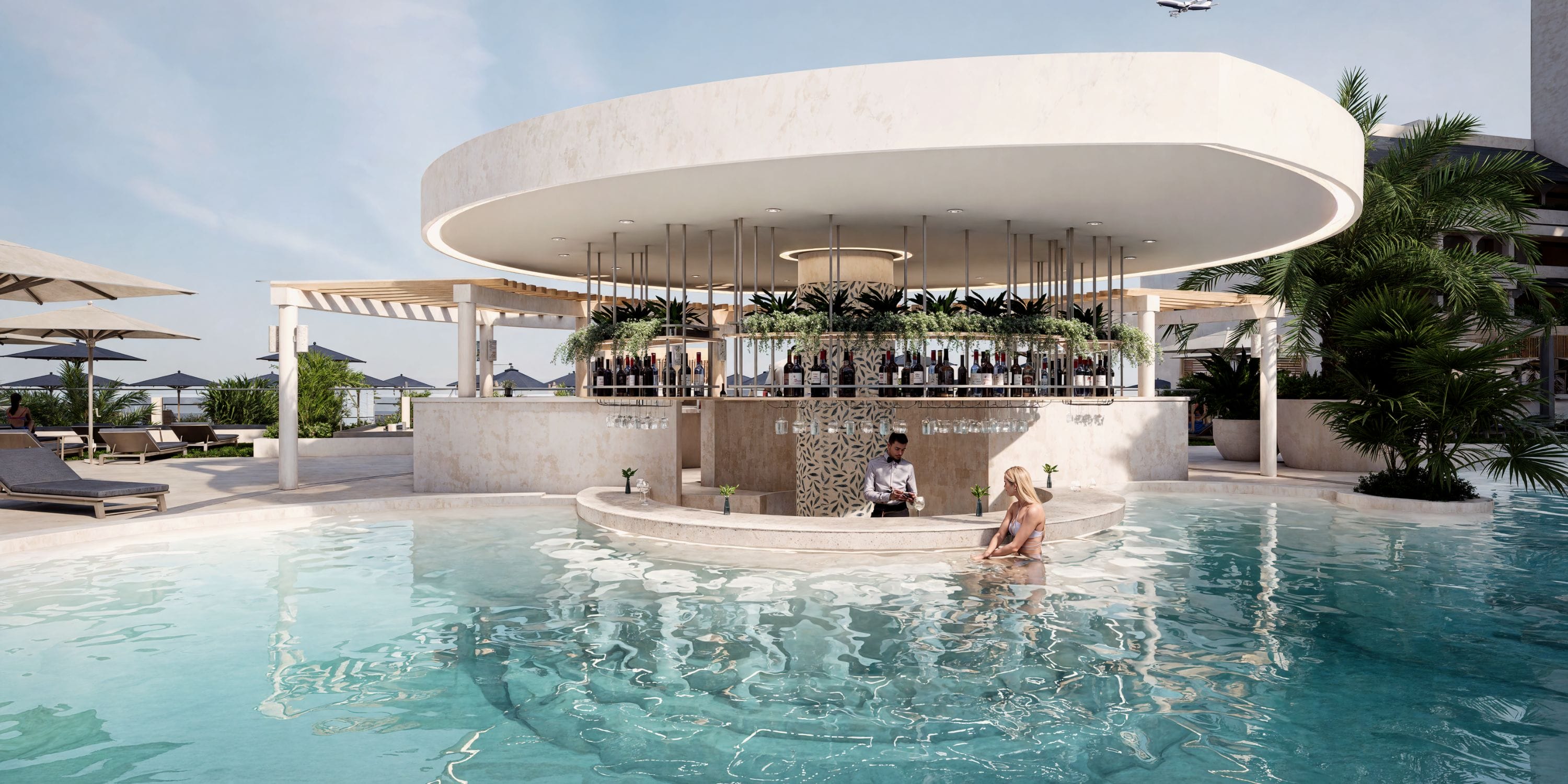A woman enjoys drinks at a swim-up bar under a canopy at a destination wedding resort.