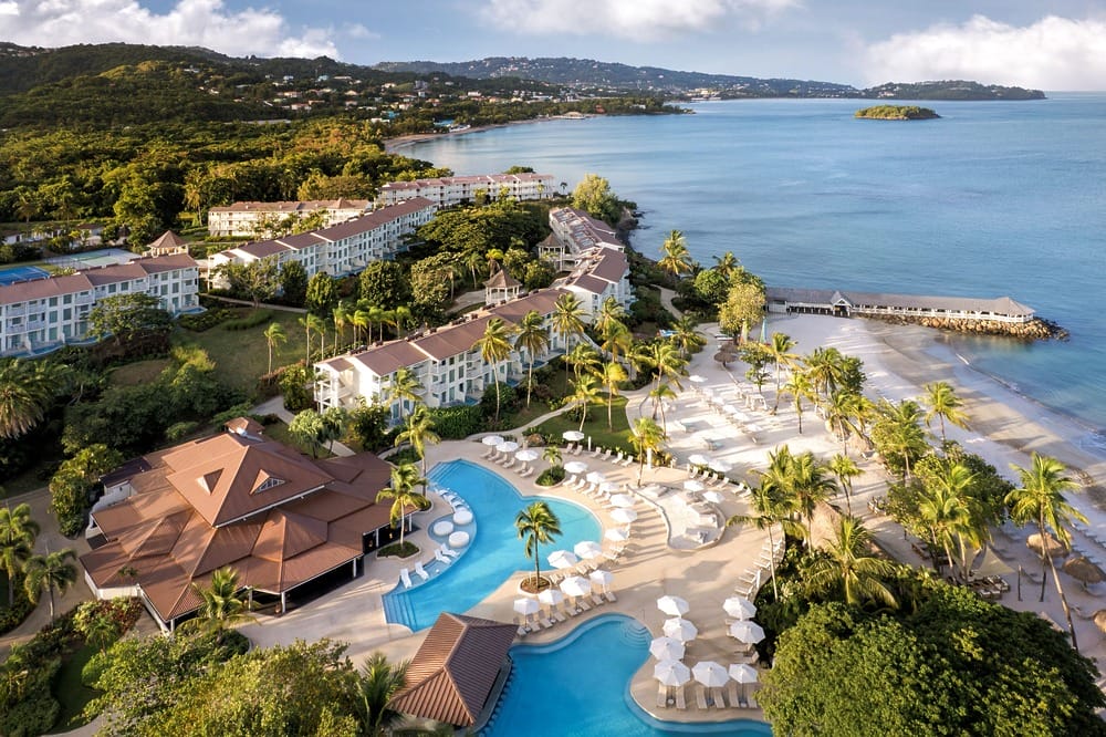 A beachfront resort with pools and palm trees, ideal for a destination wedding by the ocean.