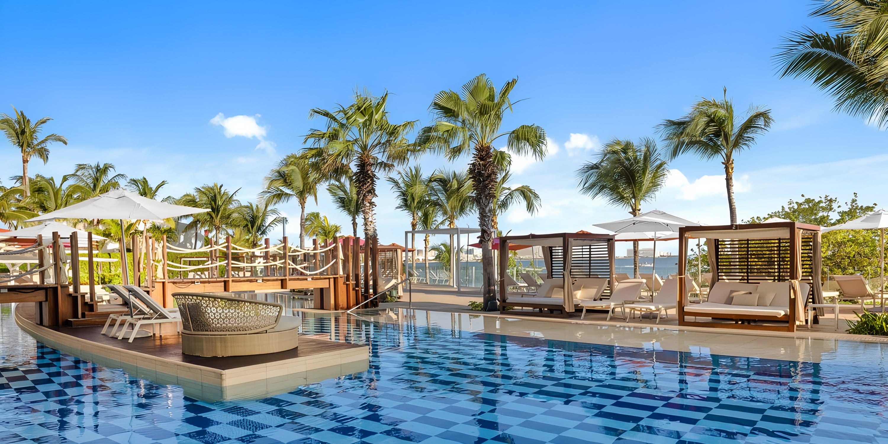 Outdoor pool at Breathless Cancún Soul, ideal for destination weddings, with cabanas and palms.