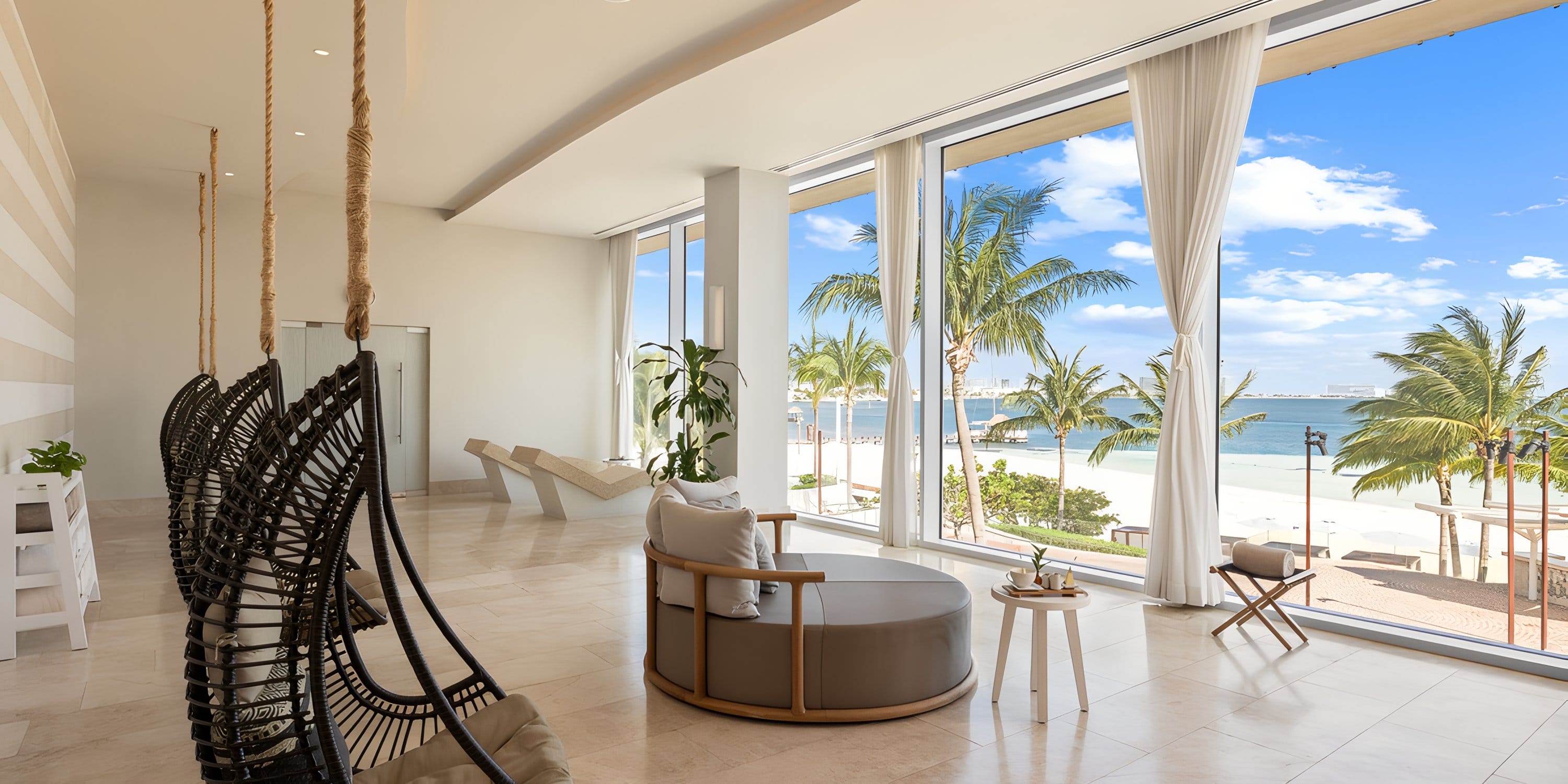 The modern lounge, ideal for a destination wedding, features hanging chairs and ocean views.
