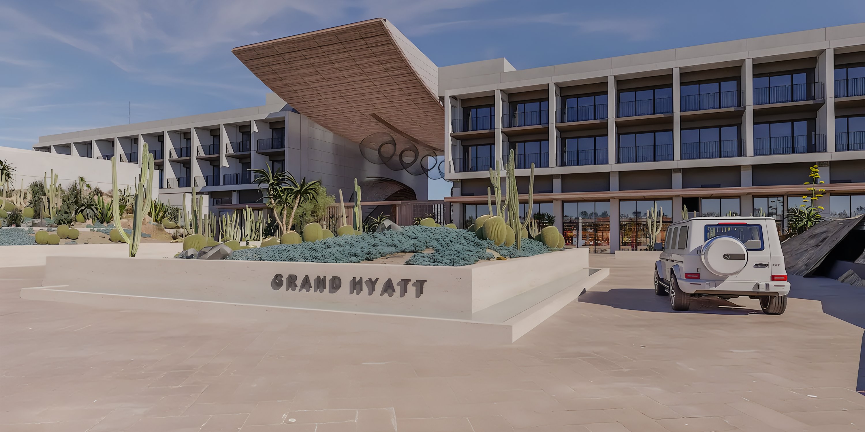 Grand Hyatt Los Cabos Resort with desert landscaping and SUV—ideal for destination weddings.