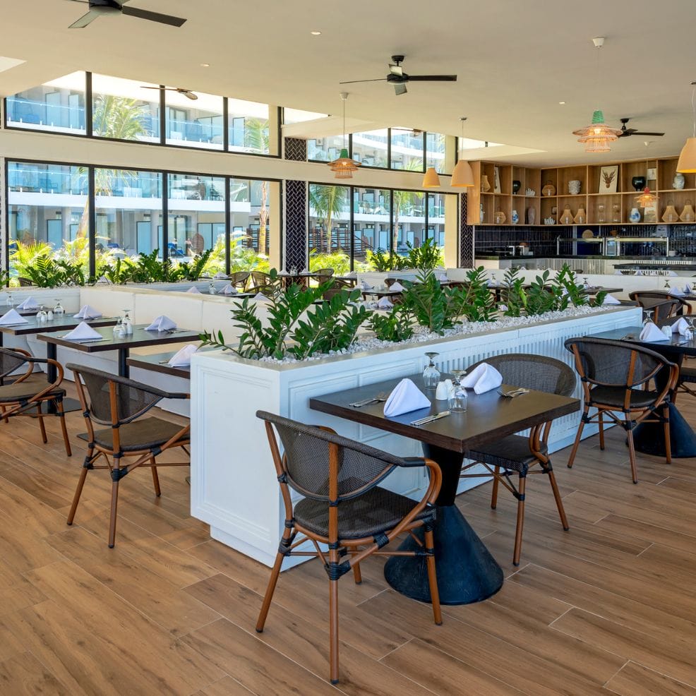 Modern restaurant with wooden floors, set tables—an elegant spot for a destination wedding.