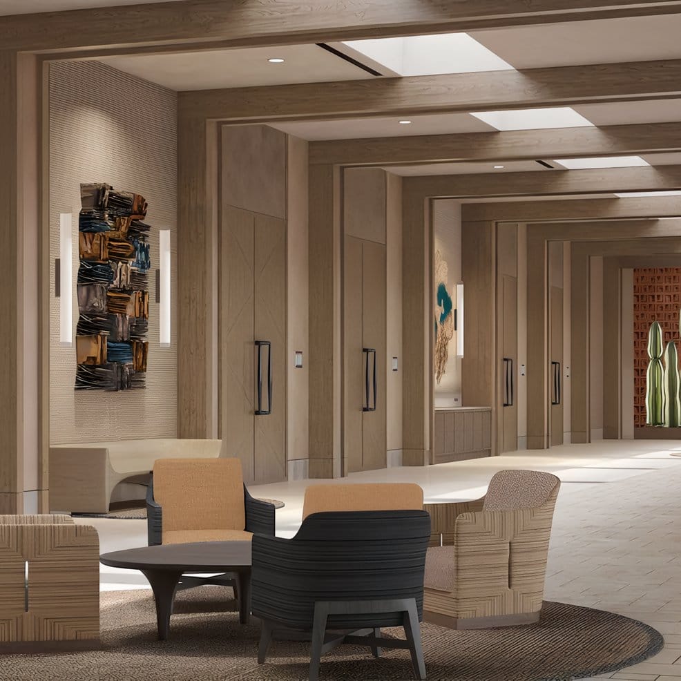 Modern lobby suited for a destination wedding, with four chairs, table, art, and skylights.