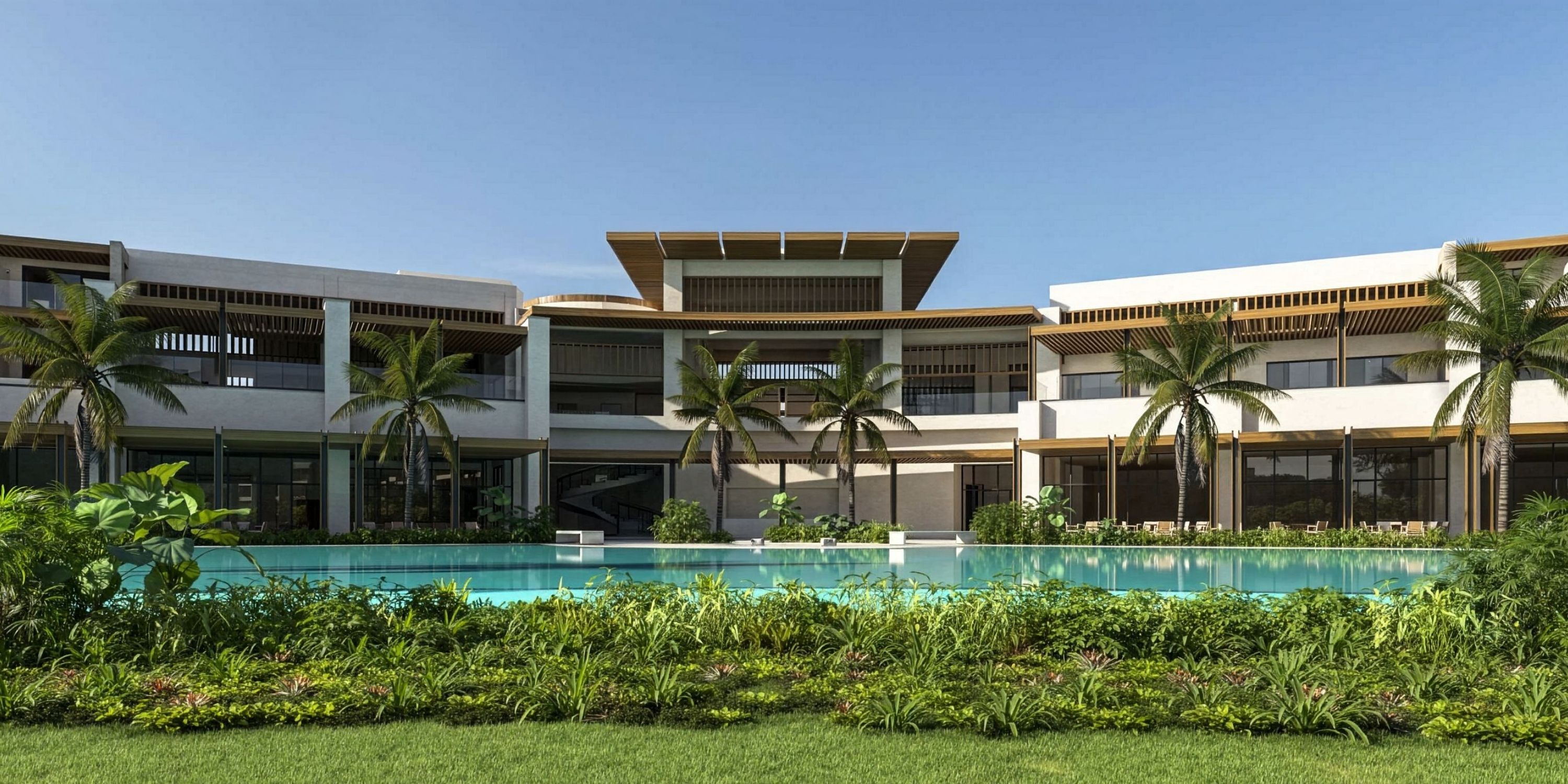 Destination wedding setup at Dreams Macao Beach, palm trees and pool beneath a clear blue sky.