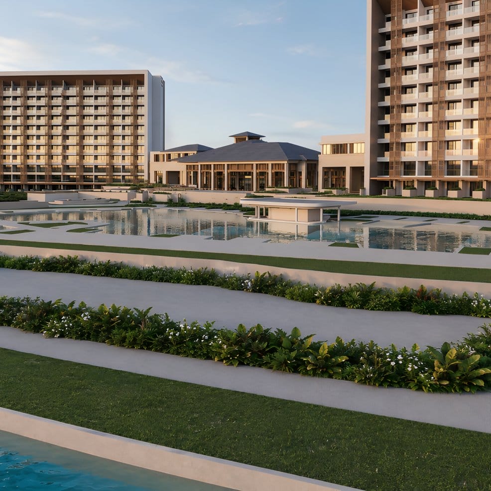 Modern hotel with large windows, gardens, and pools at sunset—ideal for a destination wedding.