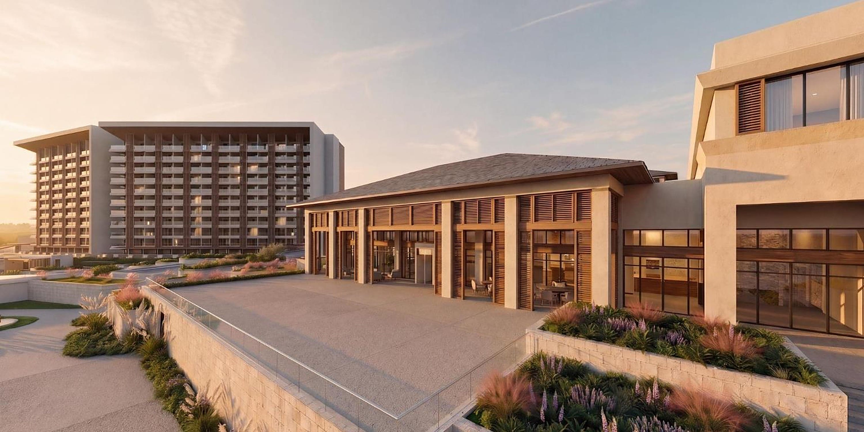 A large modern resort building with a terrace, perfect for a destination wedding.
